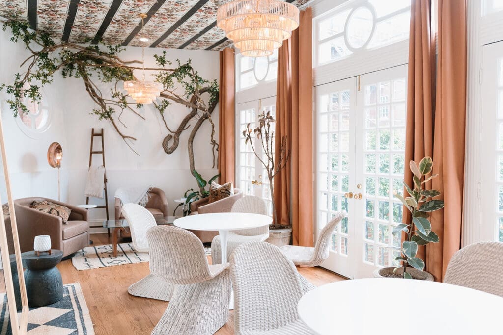 Historic interior of Swann House featuring chandeliers and tall windows — photo by Morgan Kay Photo