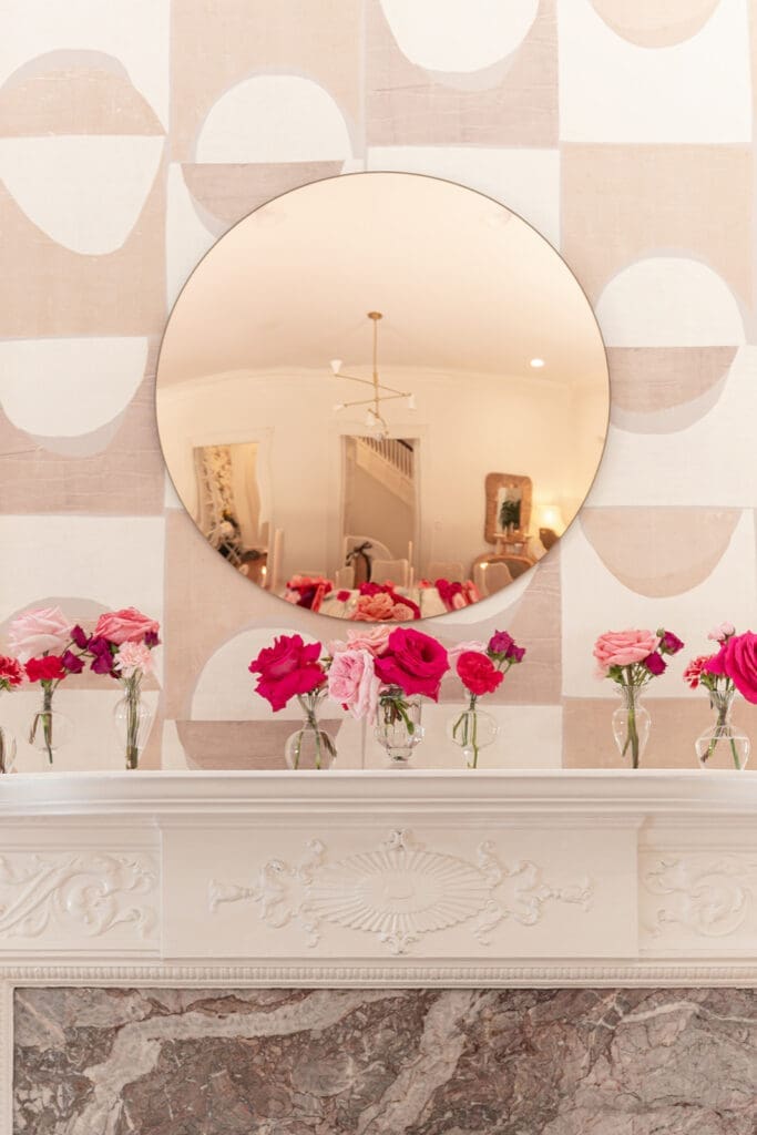 Bright pink and red florals, embroidered linens, and glassware from a Modern Parisian wedding editorial at Swann House, designed by Chelsea Quenum Wedding Planning & Event Design.