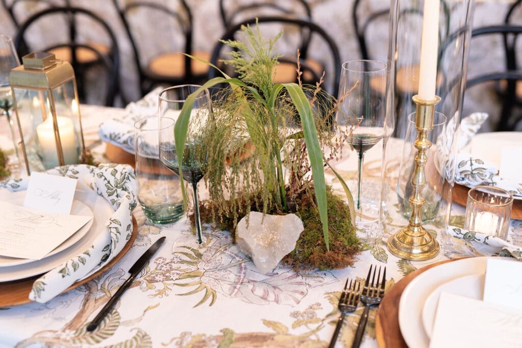 Elevated woodland garden table design with moss, mushrooms, and candlelight at Clyde’s Willow Creek Farm.