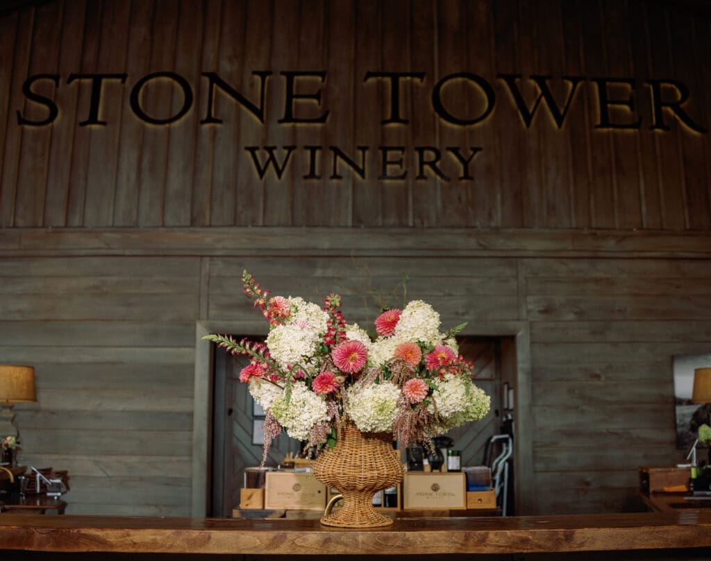 Romantic floral arrangement inside Stone Tower Winery, showcasing elegant design and natural textures.