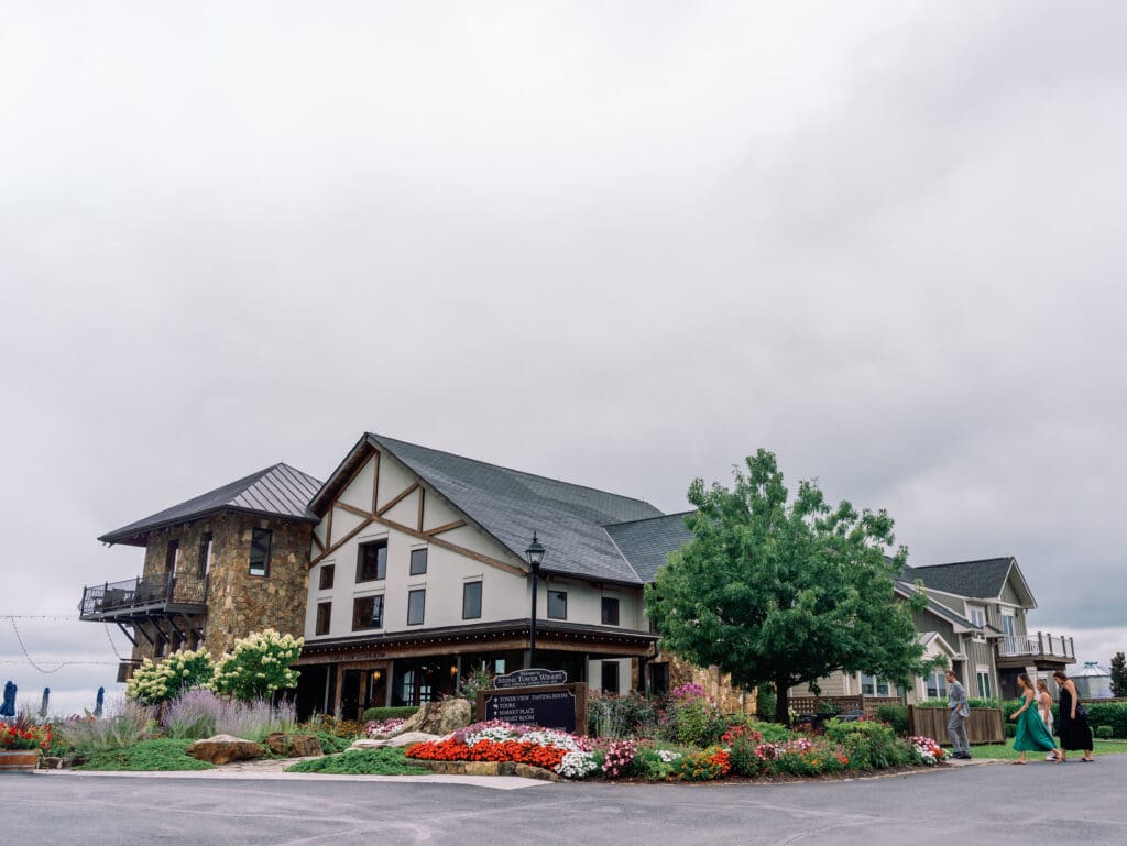 The exterior of Stone Tower Winery, a sought-after Northern Virginia wedding venue with inviting architecture and scenic grounds.