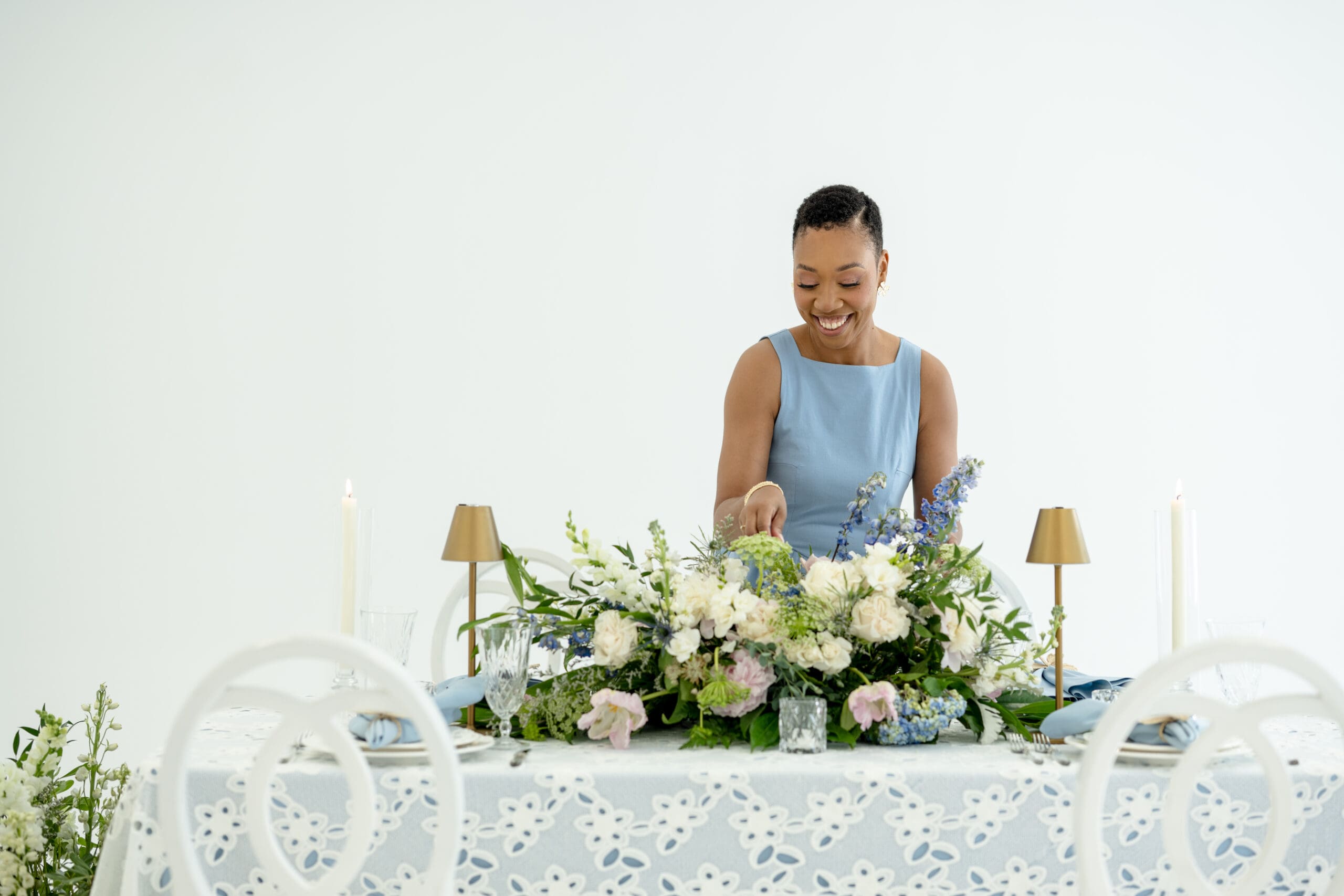 Chelsea Quenum styling a cohesive tablescape with florals, linens, and candlelight.