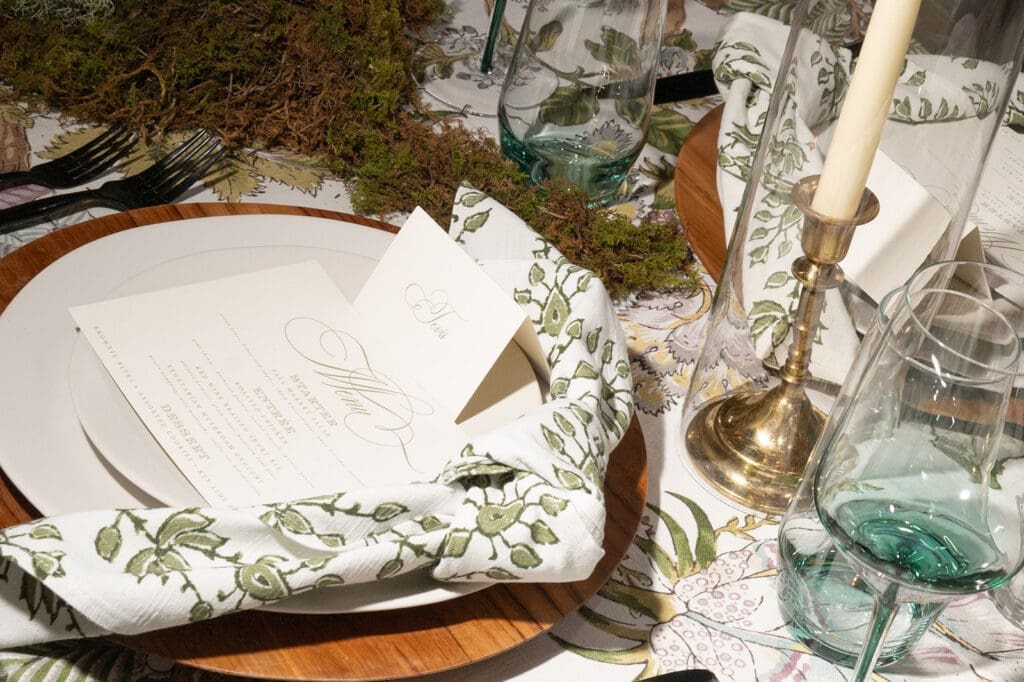 Place setting with menu and linen detail during wedding reception setup