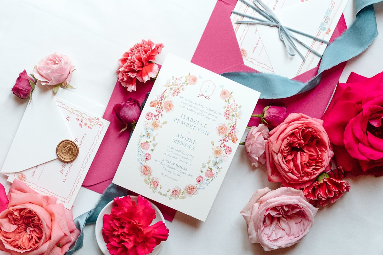 Colorful wedding invitation suite with pink and red florals, blue silk ribbon, wax seal, and illustrated stationery for a Swann House editorial wedding.